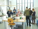 Two groups of short course participants in the piston cylinder lab